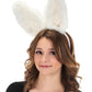 A woman wearing white bendy plush bunny ears.