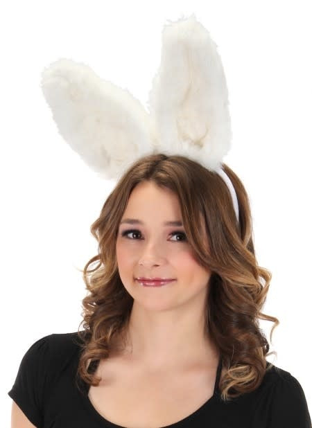 A woman wearing white bendy plush bunny ears.