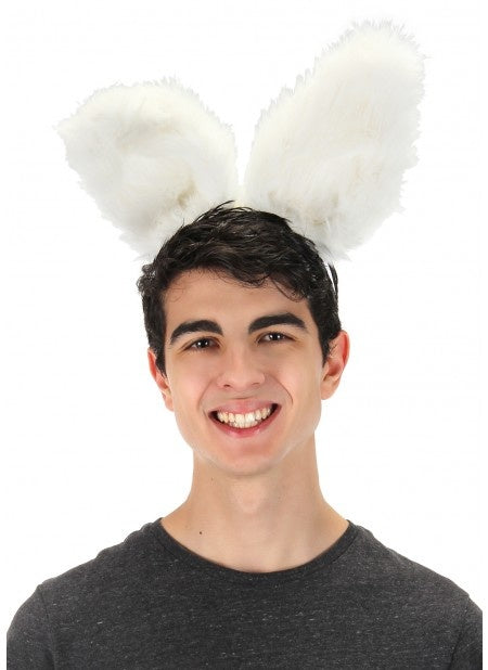 A man wearing white bendy plush bunny ears.