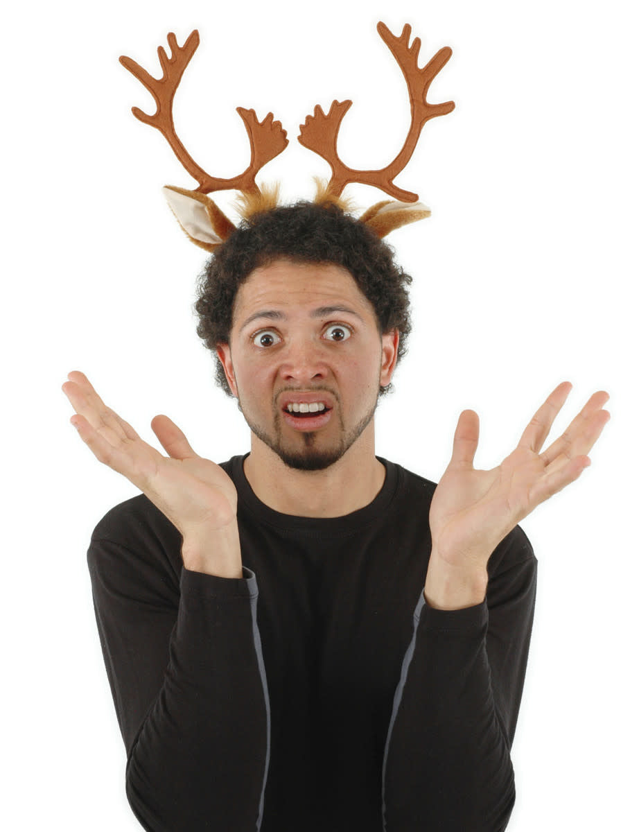 A man waving his hands while wearing a reindeer ears & antlers headband. 