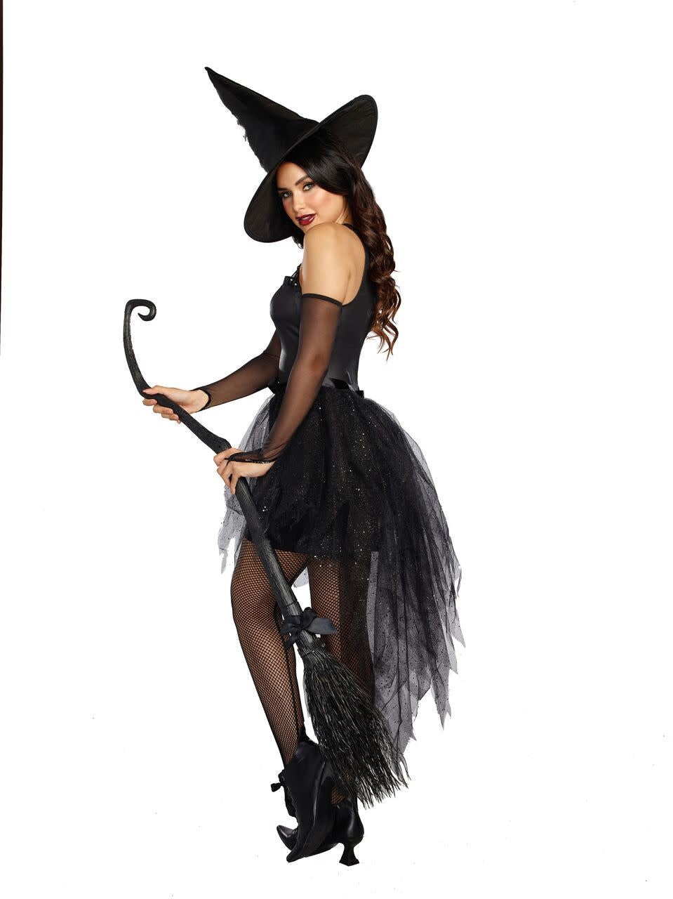 A woman looking over her shoulder wearing a black wicked witch costume. 