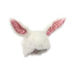 A close up of a plush rabbit ears hat.