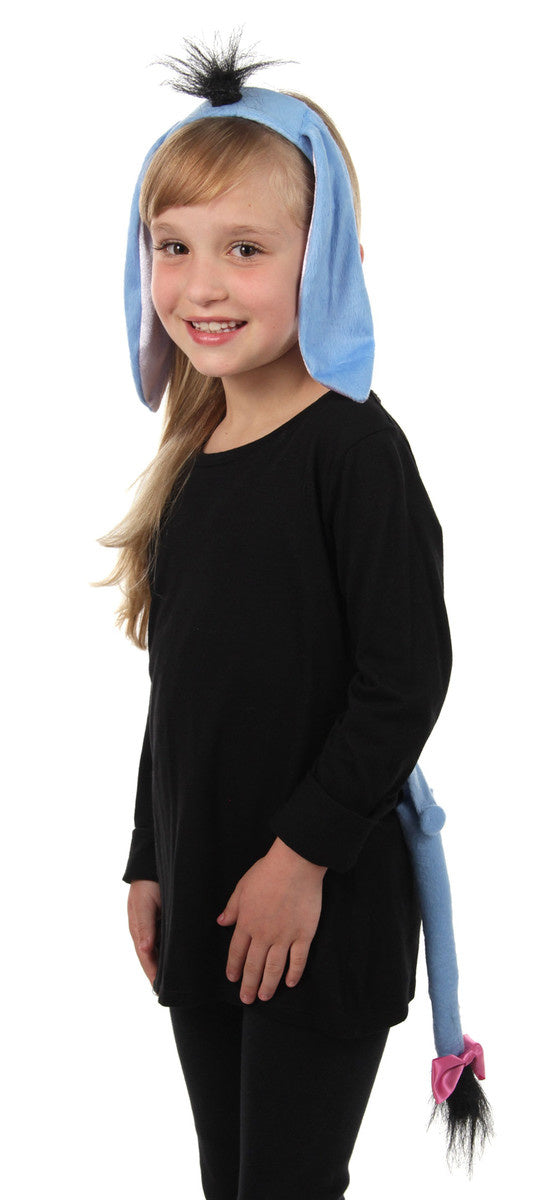 A girl wearing A woman wearing an Eeyore ears, headband, and tail kit costume .