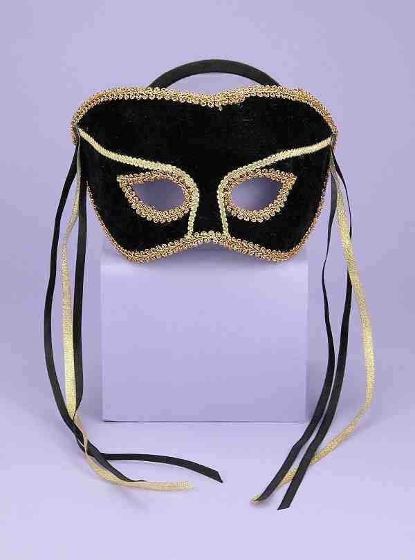 A black and gold half masquerade mask with ribbons.