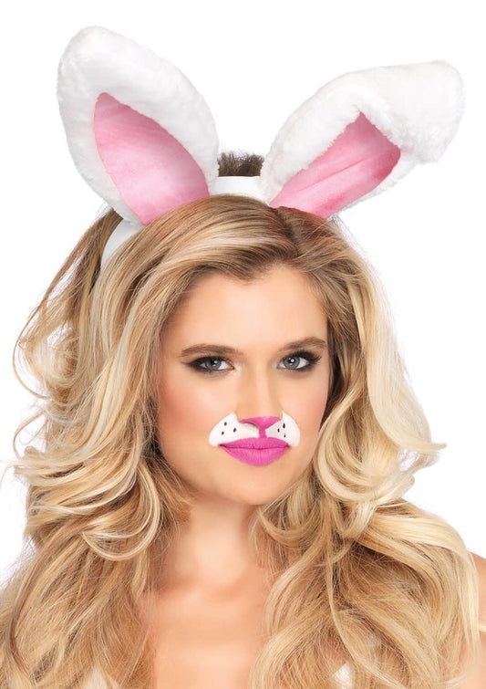 A woman wearing a pair of white plush bunny ears with a pink inner ear coloring.