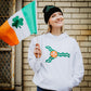 A woman wearing a St. Patrick's Day hoodie with the symbol of the flag of St. Louis, MO on it.