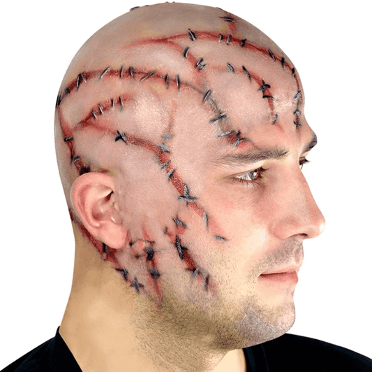 A man wearing a latex bald cap with stitches design.
