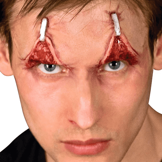 A man wearing the wide away prosthetic makeup that is giving the look of his eyes being held open by staples..